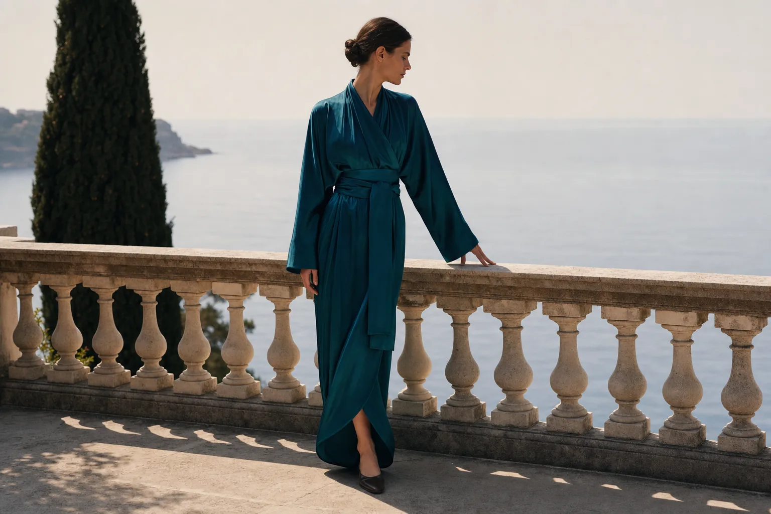 The Signature Wrap in Ocean Teal, worn on a Riviera terrace